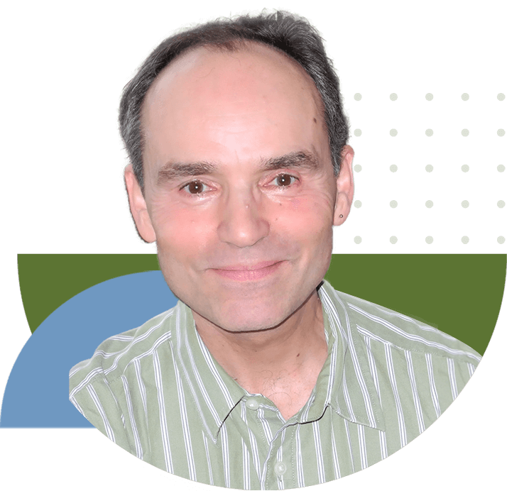 A man with a striped shirt is smiling.
